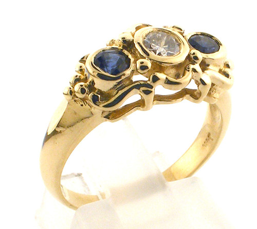 14 karat yellow gold diamond and sapphire ring weighing 3.9 grams.  Diamond approx .20ct G-H, SI1  Size 6.75