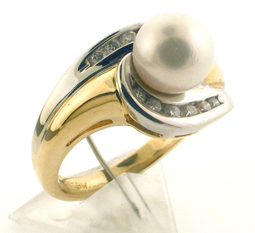 14 karat Yellow and White gold pearl and diamond ring weighing 5.4 grams. Finger size 5. Pearl is 7.0 mm/ Diamond weigh approx .25 ct tw 14 karat Yellow and White gold pearl and diamond ring weighing 5.4 grams. Finger size 5. Pearl is 7.0 mm/ Diamond weigh approx .25 ct tw