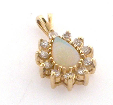 14 karat yellow gold diamond and opal pendant weighing 1.5 grams