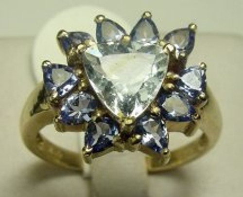 This is a 10 karat yellow gold ring with a tanzanite center stone with aquamarine stone's surrounding it. The total weight of the ring is 19.6 grams and is for a ring size of 10.25