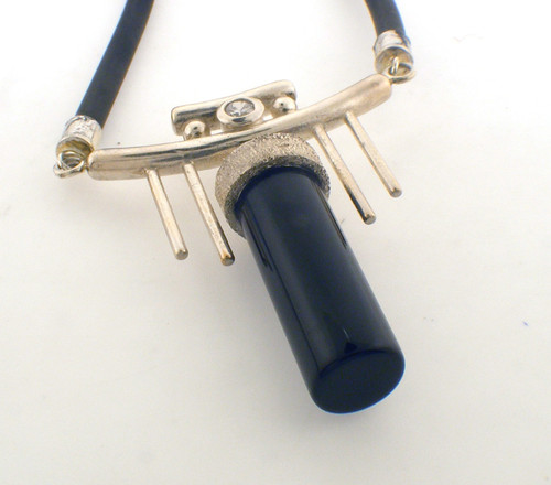 Sterling silver and rubber necklace with a cz and a cylindrical black onyx.The total length of the the necklace is 18 inches and the total weight of the necklace is 26.5 grams.