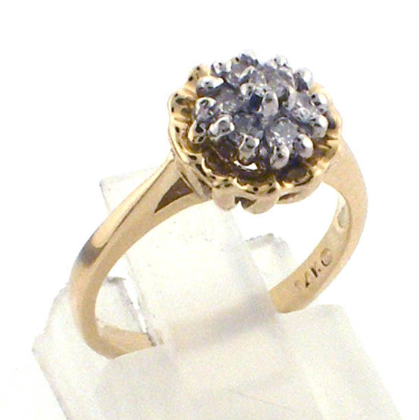 14 karat yellow gold diamond cluster ring weighing 2.8 grams.  Diamonds weigh approx .20ct tw.   Finger size 4