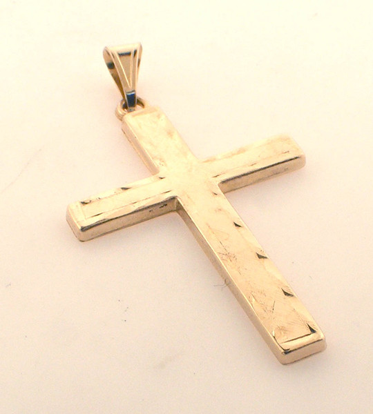 14 karat yellow gold cross weighing 1.2 grams