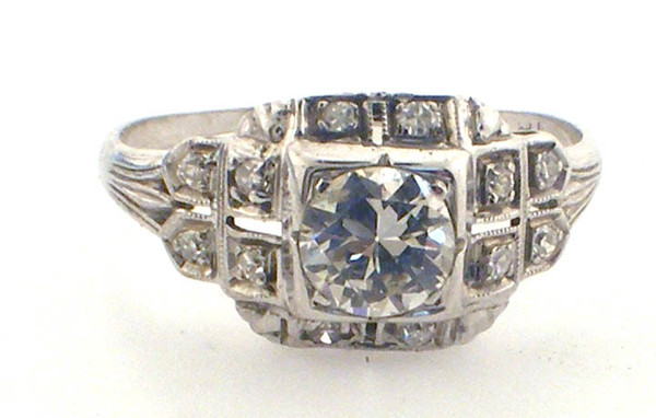 18 Karat white gold vintage diamond ring weighing 2.1 grams. Finger size 7 3/4.  side diamond approx .12ct tw. Center diamond approx .50ct I-J, VS