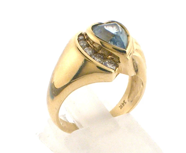 14 karat yellow gold aquamarine and diamond ring weighing 6.1 grams.   Diamonds weigh approx .12ct tw