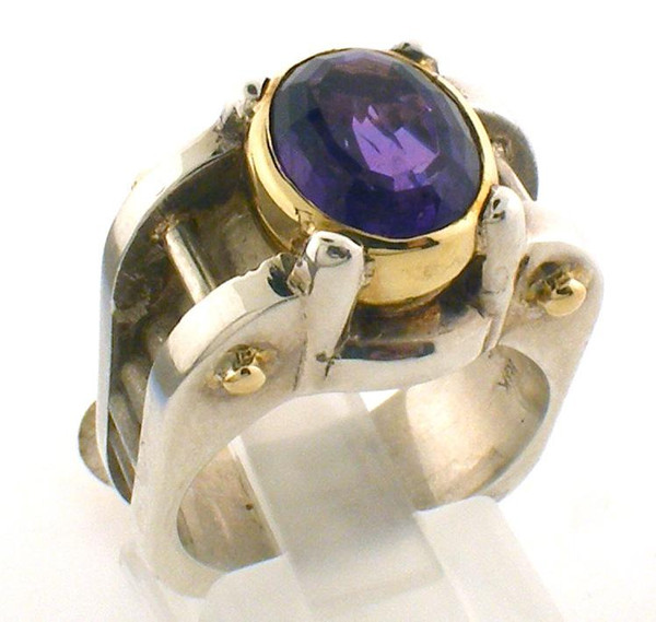 This is a custom made two tone ring featuring an amethyst bezel set in 18 karat yellow gold and two bars that cross the ring on either side of the amethyst.  Ring is a size 6.5 and weights 14.9 grams.
