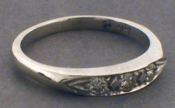 14 karat white gold diamond wedding ring weighing 2.7 grams, Diamonds weigh approx .12ct TW. Finger size 7