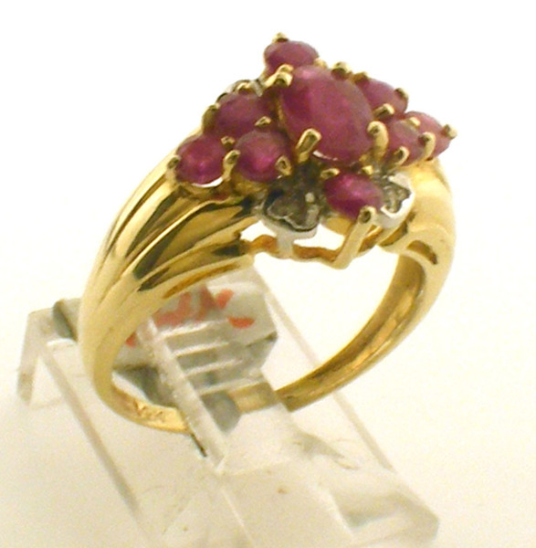 This is a 14 karat yellow gold ring with ruby's and diamonds. The diamond TW is .4ct and the ruby TW is 1.1ct. The total weight of the ring is 3.4 grams and is for a finger size of 6