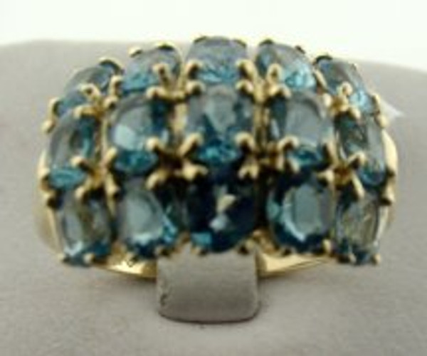 This is a 14 karat yellow gold ring with a blue topaz cluster. The total weight of the blue topaz is 3ct and the total weight of the ring is 3.9 grams. The ring was made for a finger size of 9.75
