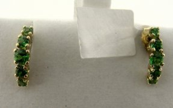 These are 14 karat yellow gold earrings with tsavorite gem stones. The total weight of both earrings is 1.2 grams.