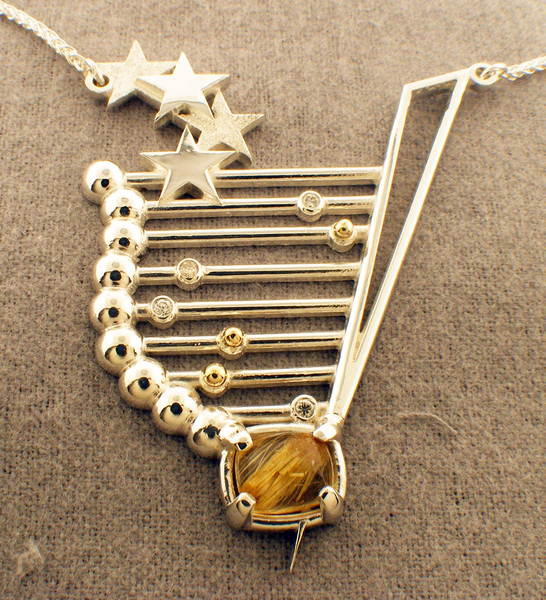 Sterling / 14k yellow gold custom made pendant.  Diamonds = .18ct tw and  contains a rutilated quartz.