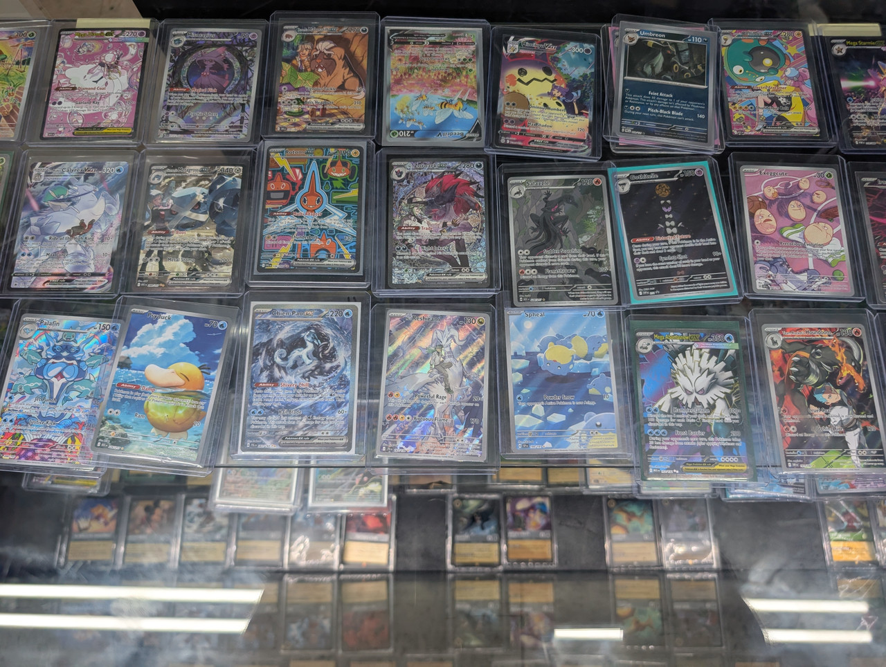 Pokémon Singles Las Vegas at The People's Card Shop Pokémon singles display case at The People's Card Shop in Las Vegas featuring rare and collectible cards