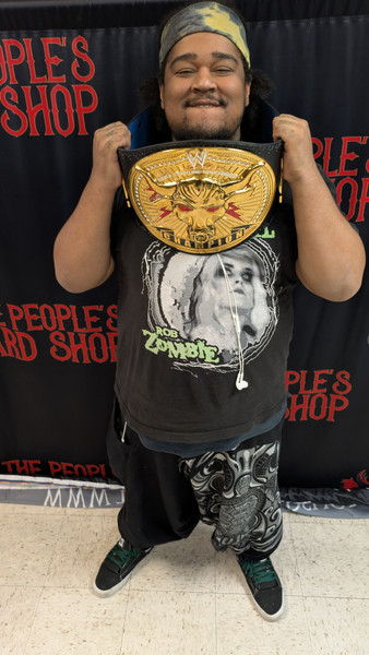 A tournament winner at The People&rsquo;s Card Shop in Las Vegas celebrating victory during a competitive trading card game event.