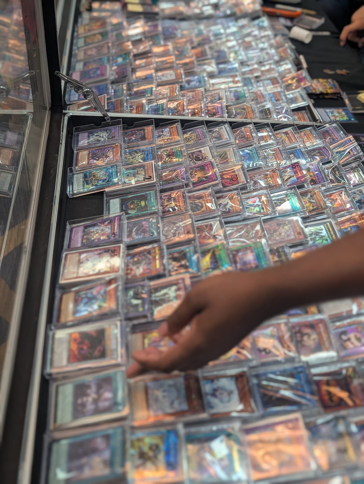 Yu-Gi-Oh! single cards in a vendor display case at a Las Vegas Regional