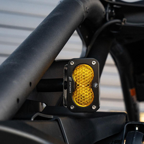 Black Baja Designs S2 Light with Baja Amber Work Scene lens mounted vertically on the back of a Can-Am Maverick R. 