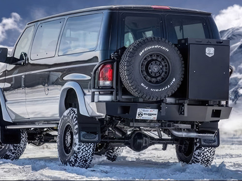 Black Ford E-Series van with an off-road rear bumper and swing arm system from Aluminess Products.