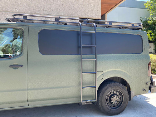 A matte green Nissan NV van with an all-aluminum side ladder and roof rack from Aluminess Products.