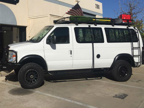 White Ford E-Series van with a side ladder and surf pole from Aluminess Products.