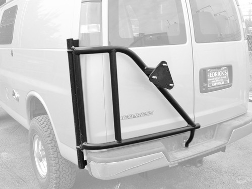 A tan-colored Chevy Express van with a driver side rear door tire rack from Aluminess Products.