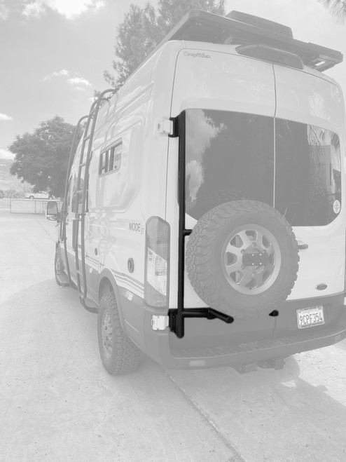 Rear view of a white Ford Transit van highlighting Aluminess Driver Side Rear Door Box/Tire Rack.