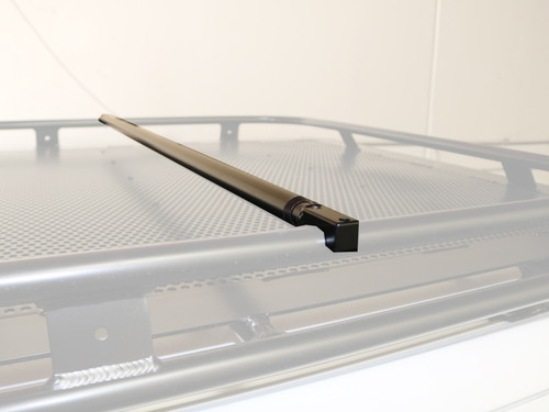 Highlighted close-up picture featuring Aluminess Adjustable Telescoping Roof Rack Crossbar on a van roof rack.
