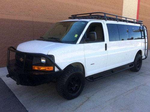 White Chevy Express van with a Weekender Roof Rack from Aluminess Products.