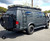 Black Ford E-Series van with an off-road rear bumper and swing arm system from Aluminess Products.