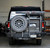 Black Ford E-Series van with an off-road rear bumper and swing arm system from Aluminess Products.