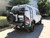 White Ford E-Series van with an off-road rear bumper and swing arm system from Aluminess Products.