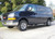 Black Chevy Express van with all-aluminum nerf bars from Aluminess Products.