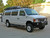 White Ford E-series van with a set of nerf bars from Aluminess Products.
