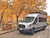Front view of a silver Ford Transit van featuring Aluminess Weekender Roof Rack.