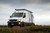 Sprinter van parked featuring Aluminess Weekender Roof Rack.