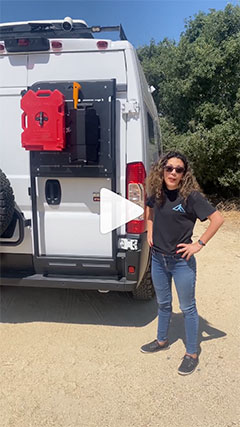 Woman Standing Next to Outfitted Overland Van