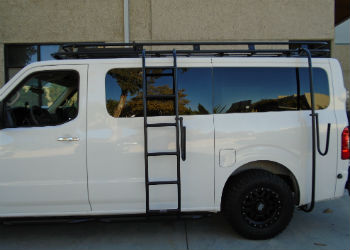 A gloss white Nissan NV van with a powder coated black side ladder, surf board mount pole, surf hooks, and roof rack from Aluminess Products.