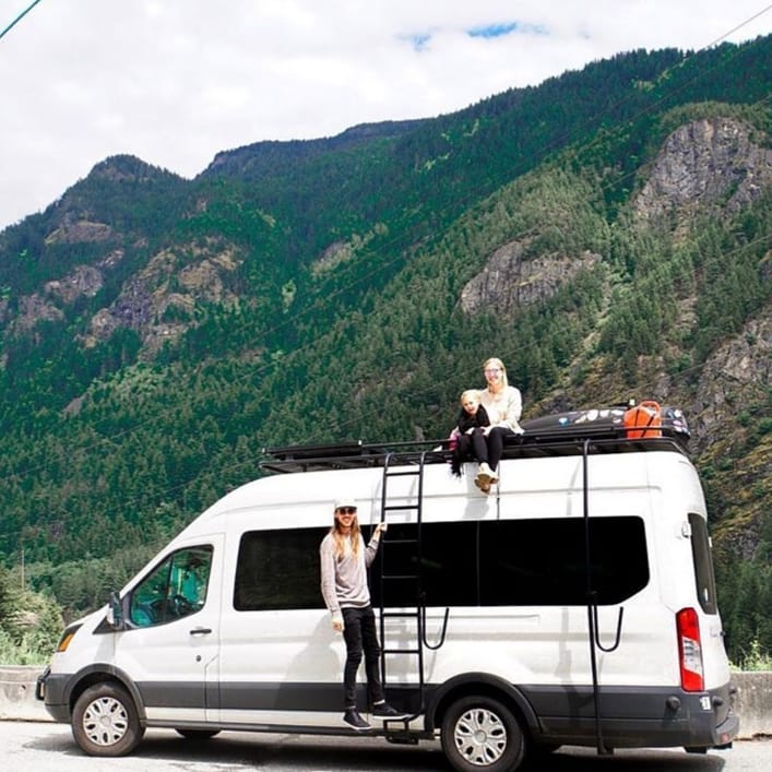 White Ford Transit van parked featuring Aluminess Surf Pole.