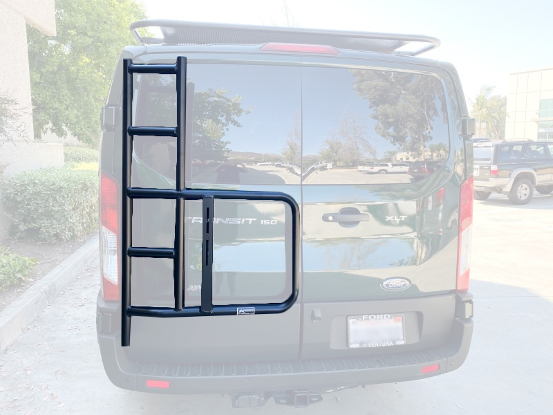 Rear view of a green Ford Transit van featuring Aluminess Rear Door Ladder.