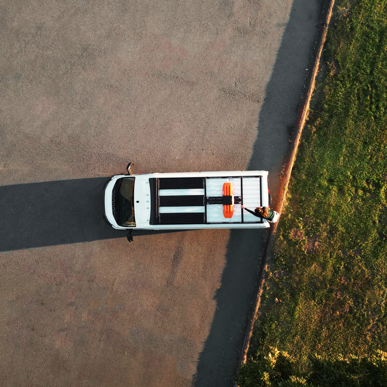 Sunset featuring DIY roof rack atop a white Dodge Promaster van.