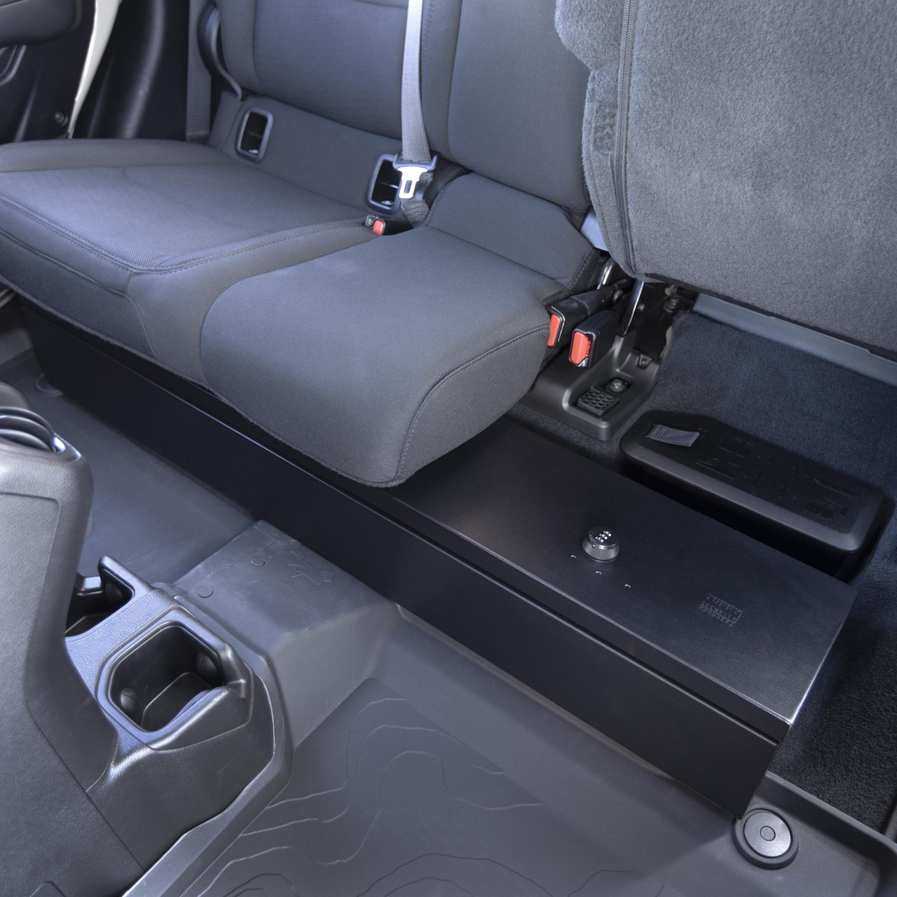 Tuffy underseat lockbox installed in rear seat area of Jeep Gladiator, showing secure steel storage with seat lifted for access.