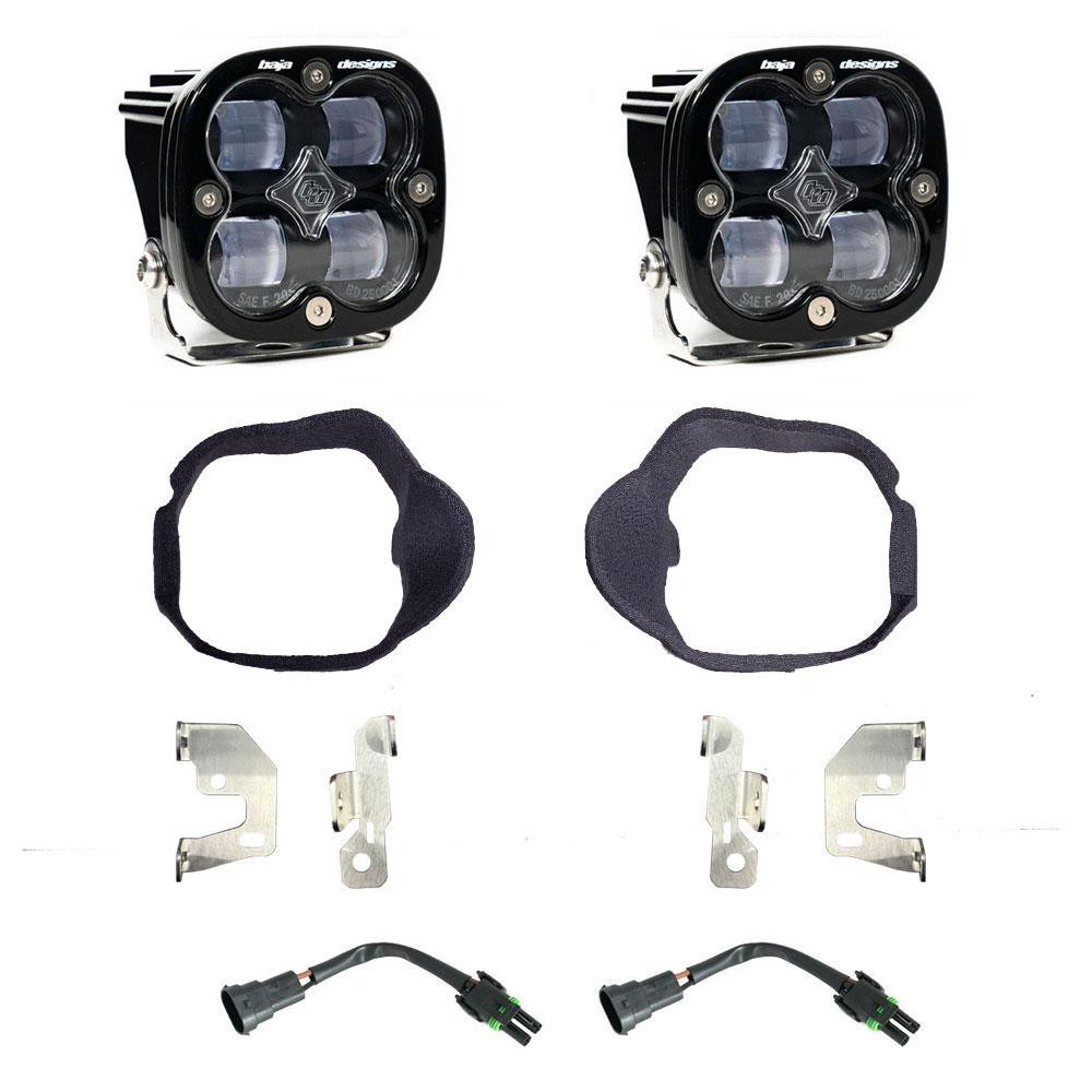 A fog light kit with clear lenses, featuring two LED lights, mounting brackets, and wiring adapters.