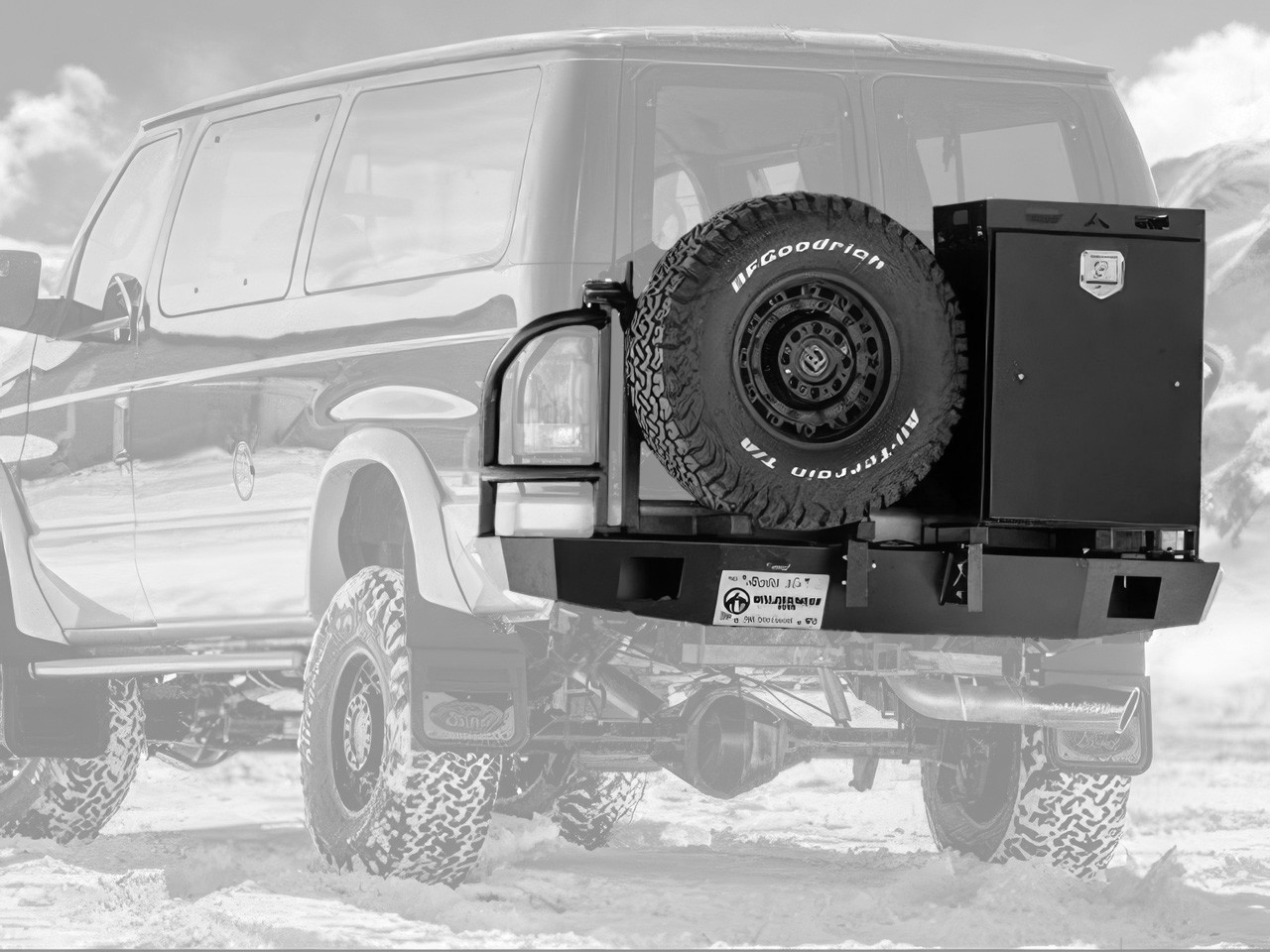 Black Ford E-Series van with an off-road rear bumper and swing arm system from Aluminess Products.