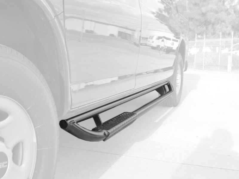 Close-up picture of Aluminess all-aluminum Nerf Bars on a Black Chevy Express parked on the street.