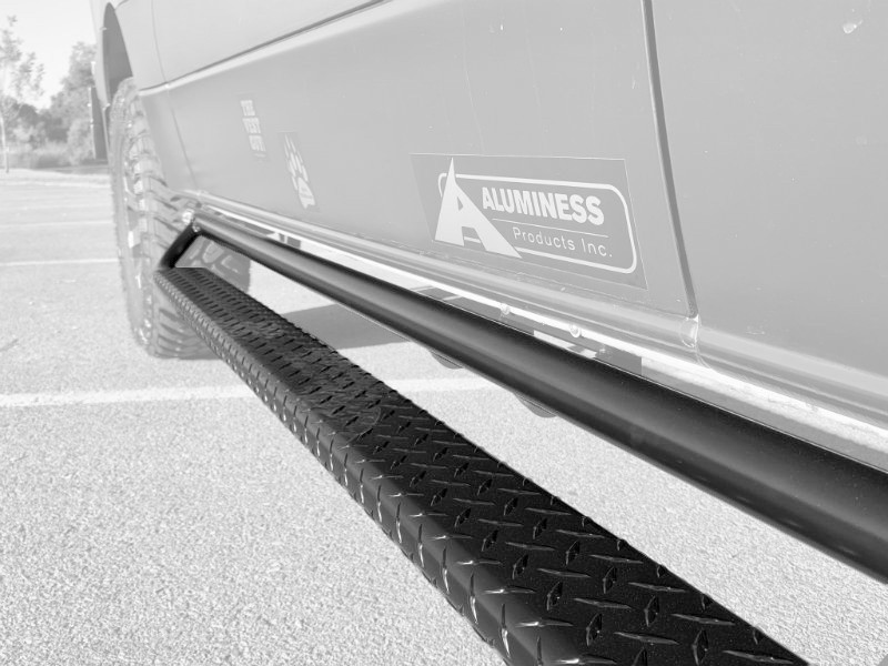 Black powder coated Nerf Bars on a Mercedes Sprinter van.