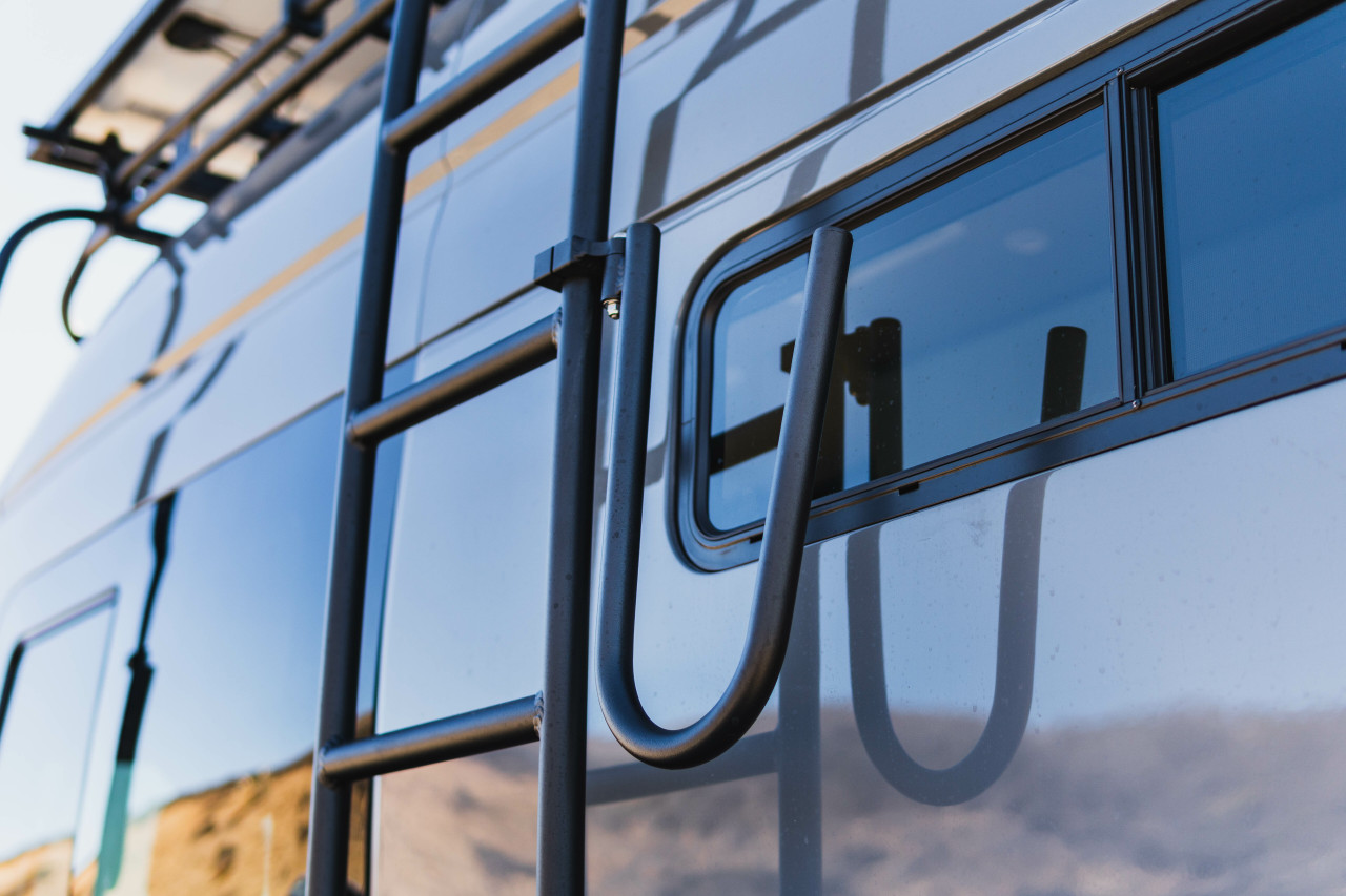 Close-up picture featuring Aluminess Side Surf Hooks on a dark van.