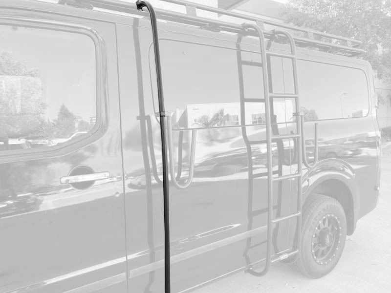 A gloss black Nissan NV van with a powder coated black side ladder, surfboard mount pole, surf hooks, and roof rack from Aluminess Products.