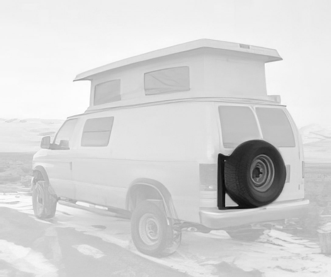 Aluminess rear door tire rack on a tan-colored Ford E-Series van.