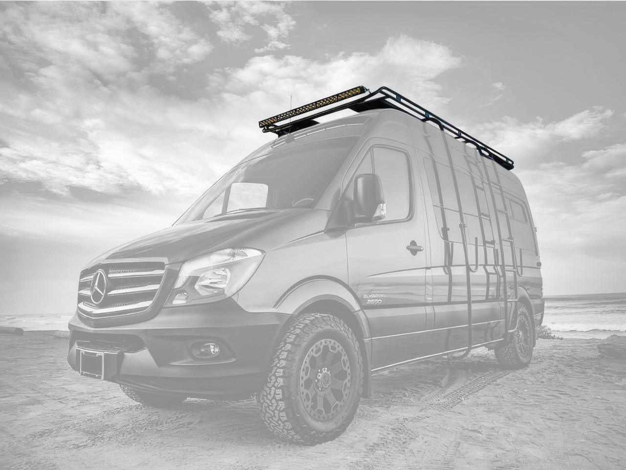 Mercedes Sprinter van parked in the desert featuring Aluminess Touring Roof Rack.