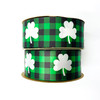 Our fun white shamrocks printed on a green and black buffalo plaid background come on satin and grosgrain!