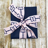 Tie a beautiful bow with our navy blue  bits lined up on a pink grosgrain ribbon.