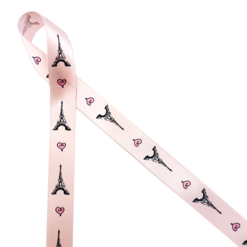 Eiffel Tower in black alternating with a pink and black heart printed on 5/8" light pink single face satin ribbon is the perfect ribbon for any occasion with a Parisian theme! This is an ideal ribbon for bridal showers, birthday parties and French themed events. Use this ribbon for party favors, party decor, cookies, cake pops, candy and chocolates. This is a great gift wrap, gift basket crafting, sewing and quilting ribbon too. All our ribbon is designed and printed in the USA